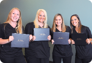 Medical Assistant Students holding their graduation certification