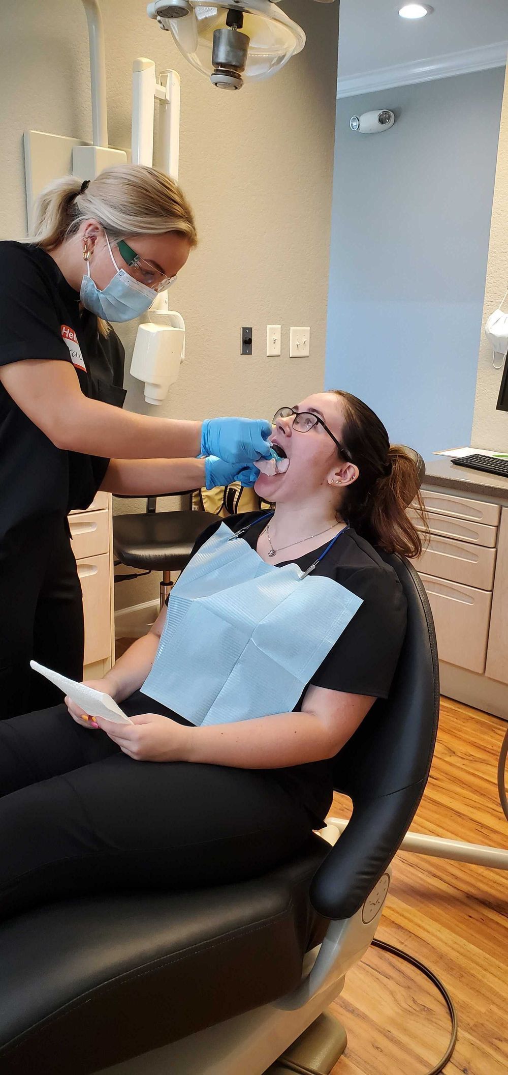 Dental assistant student in dental chair during training