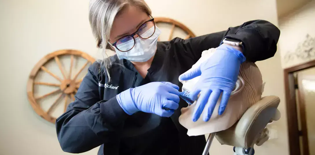Dental assistant students practicing in a school lab