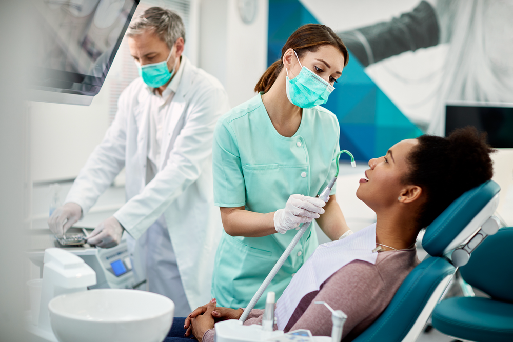 Dental assistant working chairside in a clinical setting