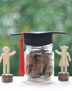 Jar of quarters covered with a Graduation cap