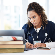 Student in dental office training with their instructor on a patient.
